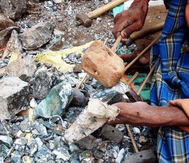 Craftman Breaking a Big Piece of Rough Rock with Cow Horn Hammer.JPG